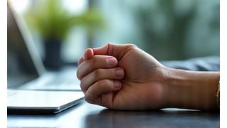 Person taking a deep, calm breath in an office setting, representing midday calm.